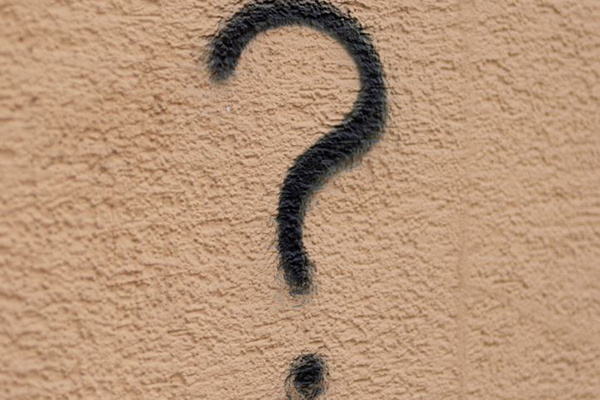 Question mark written on a wall.