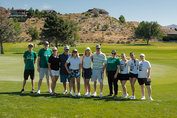 Members of the GBC Golf Team and volunteers posing off the green at Ruby View Golf Course.