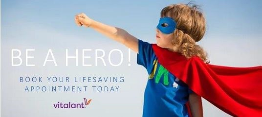 Young girl in superhero costume and blood drive text.