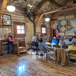 An audience listens to a speaker.