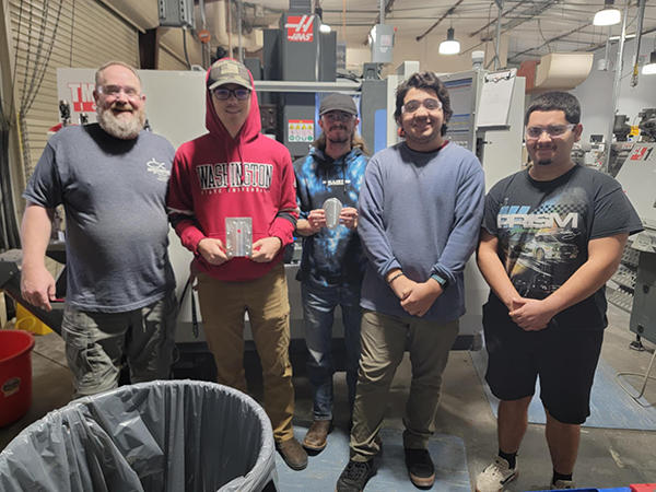 MTT students pose in front of their lab.