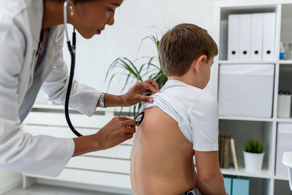 Cardio-Respiratory technician examining a child.