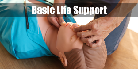 A man practices CPR on a dummy, with text Basic Life Support.